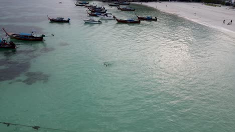 Many-longtail-boats-anchored-in-the-Andaman-Sea-of-Koh-Lipe-Island-in-Thailand-during-sunset