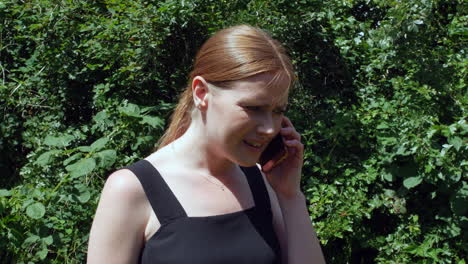 A-girl-with-red-hair-is-disappointed-after-receiving-a-phone-call-with-bad-news