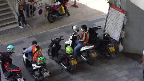 Motorbike-taxi-riders-waiting-for-customers-downtown-Bangkok