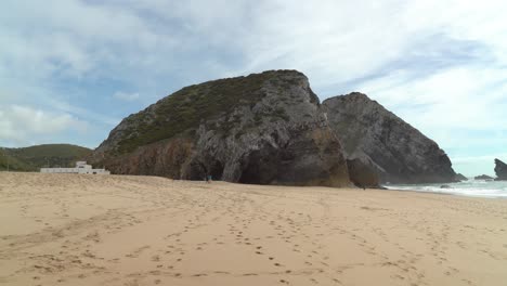 Gruta-da-Adraga-Caves-with-Sandy-Beach-Filled-with-People-Footprints