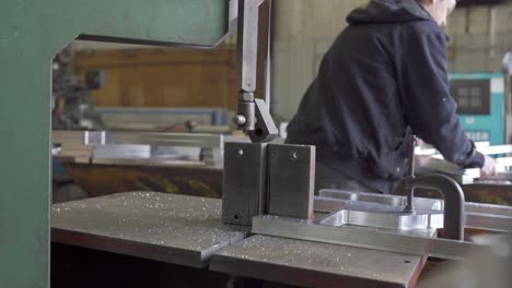 Aluminum-Being-Cut-On-A-Industrial-Bandsaw-In-A-Metal-Workshop