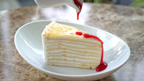 vanilla-crepe-cake-with-raspberry-and-strawberry-sauce-on-plate