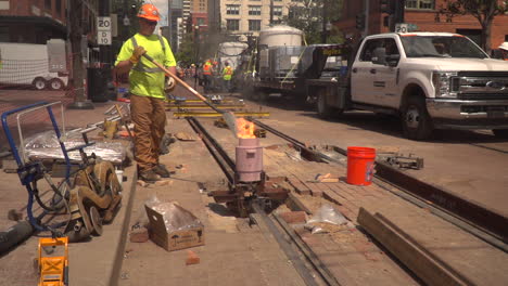 Construction-Worker-welds-train-tracks-with-extremely-high-heat-and-molten-steel