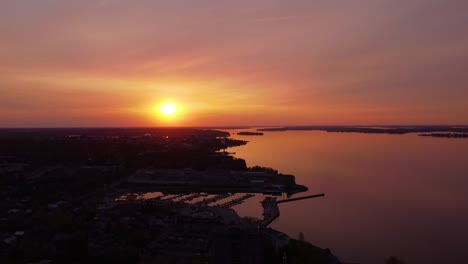 Aerial-red-sky-sunset-near-city-waterfront-view