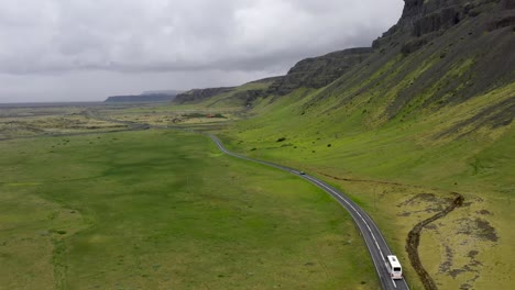 Tour-bus-driving-through-the-mountains-of-Iceland-with-drone-video-following