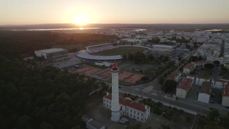 Sunset-aerial-around-Vila-Real-de-Santo-Antonio-lighthouse,-Portugal