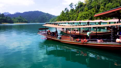 View-Of-Traditional-Longboats-Moored-At-Pier-On-Cheow-lan-lake-Located-In-Khao-Sok-National-Park