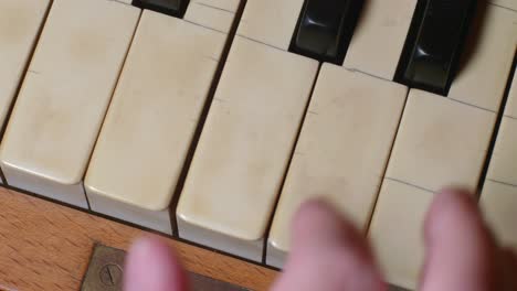 Overhead-Shot-Of-Fingers-Playing-A-Chord-On-A-Piano