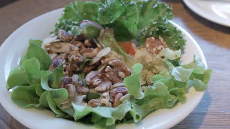 using-fork-eat-fresh-salad-in-white-bowl-for-breakfast