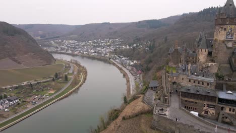 drone-flight-passes-the-cochem-castle-and-over-the-river-moselle-with-a-wide-view-of-the-city