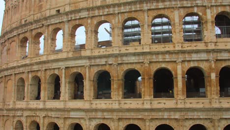 Close-up-of-the-remains-of-the-roman-empire-the-famous-ancient-and-historic-colosseum-in-Rome,-Italy