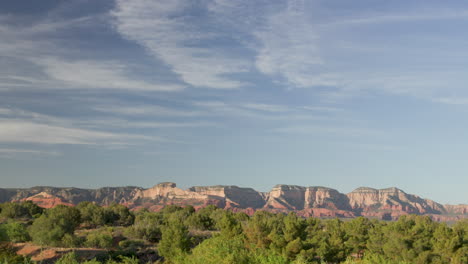 Bottom-weight-static-shot-of-Sedona-Red-Rock-mountains-with-blue-sky-and-wispy-clouds