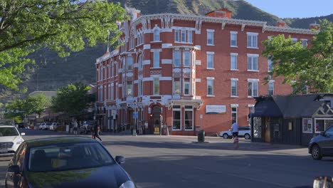 People-crossing-the-street-in-front-of-the-Starter-hotel-in-downtown-Durango,-Colorado