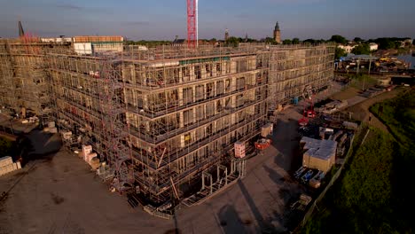 Facade-in-scaffolding-of-Kade-Zuid-real-estate-project-of-luxury-apartments-aerial-in-Noorderhaven-neighbourhood-seen-from-above