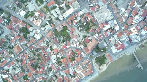 Overhead-Drone-Shot-Revealing-Stunning-Larnaka-Cityscape,-Bricks-Houses-Roof,-Cyprus,-Europe
