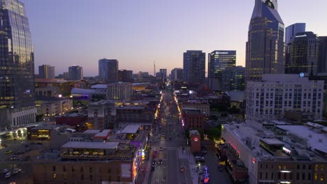Aerial-view-overlooking-bars-and-country-music-clubs-at-the-illuminated-Broadway-street,-evening-in-Nashville,-USA