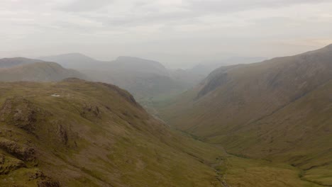 Pushin-Drone-Shot-of-Mountains-and-Valley-in-England-during-Morning-in-Overcast-Weather