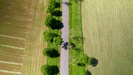 Wide-Ranging-Cultivated-Land-And-Concrete-Road-Pavement-In-The-Countryside-Of-Warmia-Mazury-Province,-Poland