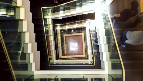 Looking-Down-Square-Glass-and-Metal-Stairs-Case-with-camera-moving-down