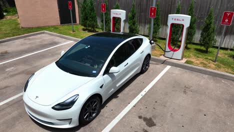 Close-up-of-Tesla-Model-3-charging-battery-at-a-Tesla-supercharger-station