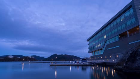 Boats-used-by-workers-to-commute-to-work-are-docked-at-office-building-in-Florvaag,-Norway
