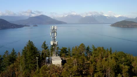 Towering-Cell-Site-In-A-Verdant-Environment-With-Placid-Seascape-And-Distant-Mountain-View-In-Horseshoe-Bay,-BC,-West-Vancouver,-Canada
