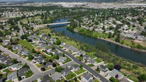 Orbiting-aerial-shot-of-neighborhoods-along-the-Spokane-River's-banks