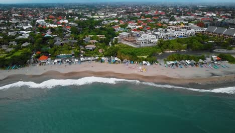Cinematic-drone-footage-of-Berawa-beach-in-Canggu,-Bali-with-beautiful-landscape,-expensive-hotels-and-villas-through-calm-weather