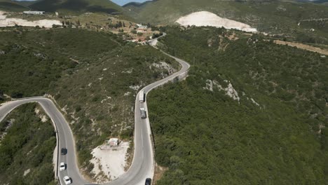 Aerial-View-Of-Vehicles-Driving-On-Uphill-Winding-Road-In-Zakynthos,-Greece