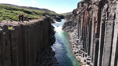 Flying-between-basalt-columns-in-Studlagil-Canyon-in-East-Iceland---Tourist-EDITORIAL