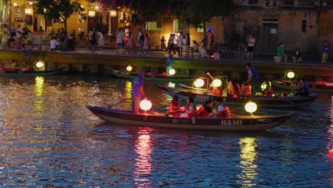 Fleet-of-lantern-lit-pagoda-canoe-boats-at-Hoi-An-Vietnam