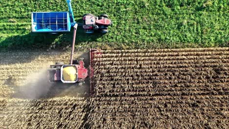 Heavy-duty-agricultural-machinery-harvesting-cereal-crops-in-the-USA,-Bird’s-eye-view