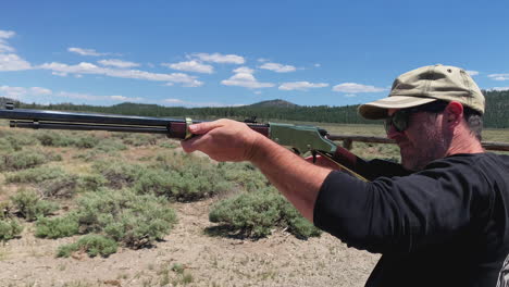 Man-shooting-vintage-gold-lever-action-22-rifle-picturesque-outdoor-firing-range