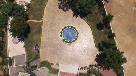 Overhead-Shot-Of-Beautiful-Water-Blue-Fountain-In-Front-Of-Castle,-Baissour,-Lebanon