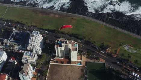 Paraglider-flying-over-city-of-Cape-Town,-South-Africa