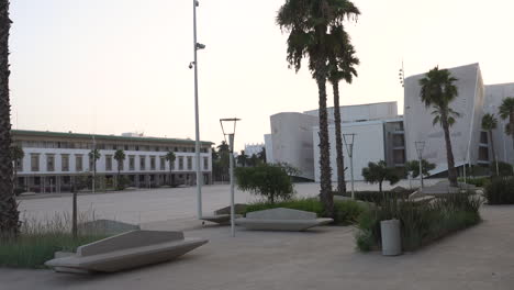 Right-pan,-new-Casablanca-Great-Theater,-empty-Mohammed-V-square-garden-at-sunrise