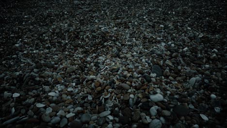 Moving-Over-Beach-Pebbles-At-Sunset