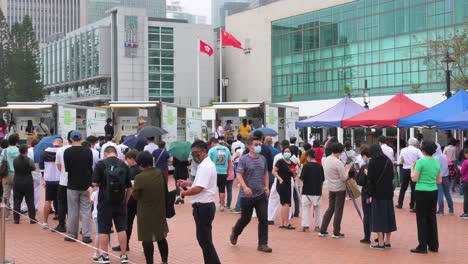 Residents-queue-in-line-to-receive-PCR-tests-for-coronavirus-from-a-Community-Testing-Centre-truck-to-tackle-the-spread-of-the-virus-and-a-pandemic-wave-near-Hong-Kong's-financial-district