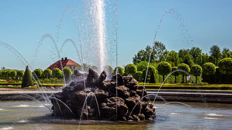 A-water-fountain-in-a-park-or-garden-on-a-clear-summer-day---time-lapse