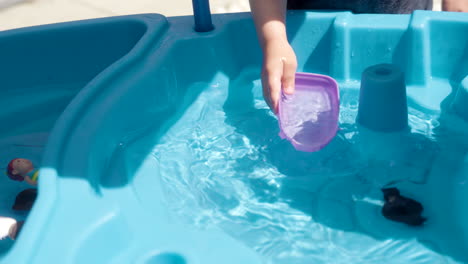 A-kid-playing-with-a-toy-boat