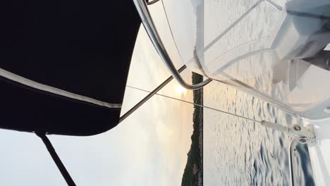 Side-view-from-the-speedboat-while-the-sun-sets-behind-the-island-in-the-distance,-Croatia