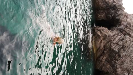 Young-blonde-girl-swims-in-the-Adriatic-Sea-near-Croatia's-Blue-Cave