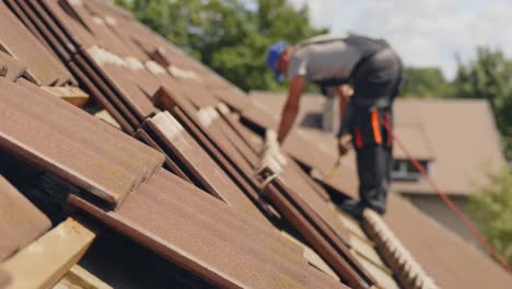 Roofer-placing-tiles-in-a-house-roof