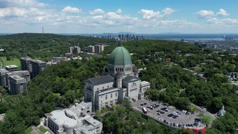 4K-Cinematic-urban-landscape-timelapse-of-a-drone-flying-around-the-Observatory-Saint-Joseph-in-Montreal,-Quebec-on-a-sunny-day,-behind-Mount-Royal-capturing-a-beautiful-panoramic-view