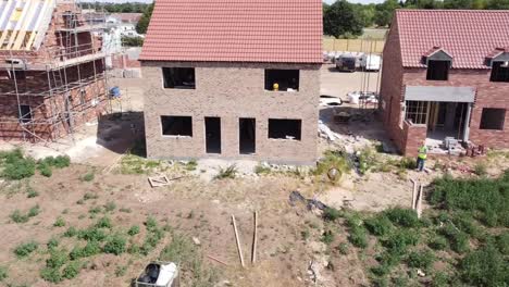 Forward-view-of-a-new-house-under-construction-flying-directly-at-the-house,-new-build-homes,-houses-for-sale,-property-boom