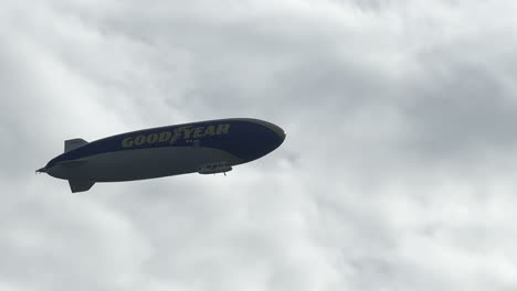 A-big-Goodyear-blimp-flying-in-a-blue-cloudy-sky-on-the-weekend