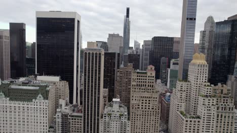Aerial-view-of-skyscrapers,-in-midtown-Manhattan,-overcast-day,-in-New-York-city,-USA---tracking,-drone-shot