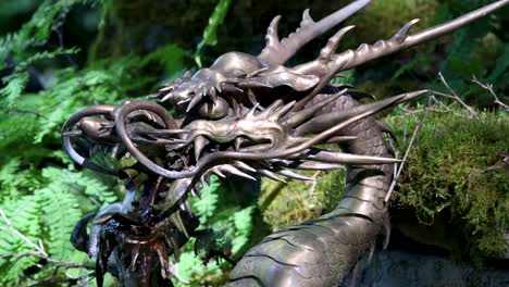 A-bronze-dragon-fountain-in-a-fern-and-moss-garden