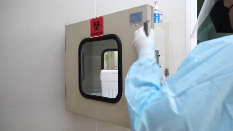 Asian-Nurse-Wear-PPE-Transfer-Foam-Storage-Box-Contain-Biohazard-Covid-19-Sample-To-Lab,-Close-Up