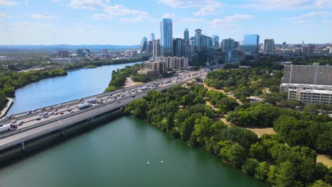 Drone-flying-away-from-rush-hour-traffic-in-Austin,-Texas